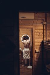 Man getting out of the shower and looking in the mirror