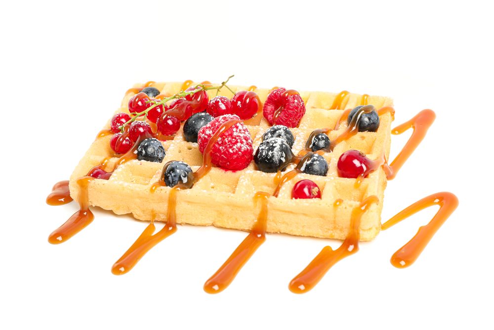 Waffle under caramel topping isolated on blank background