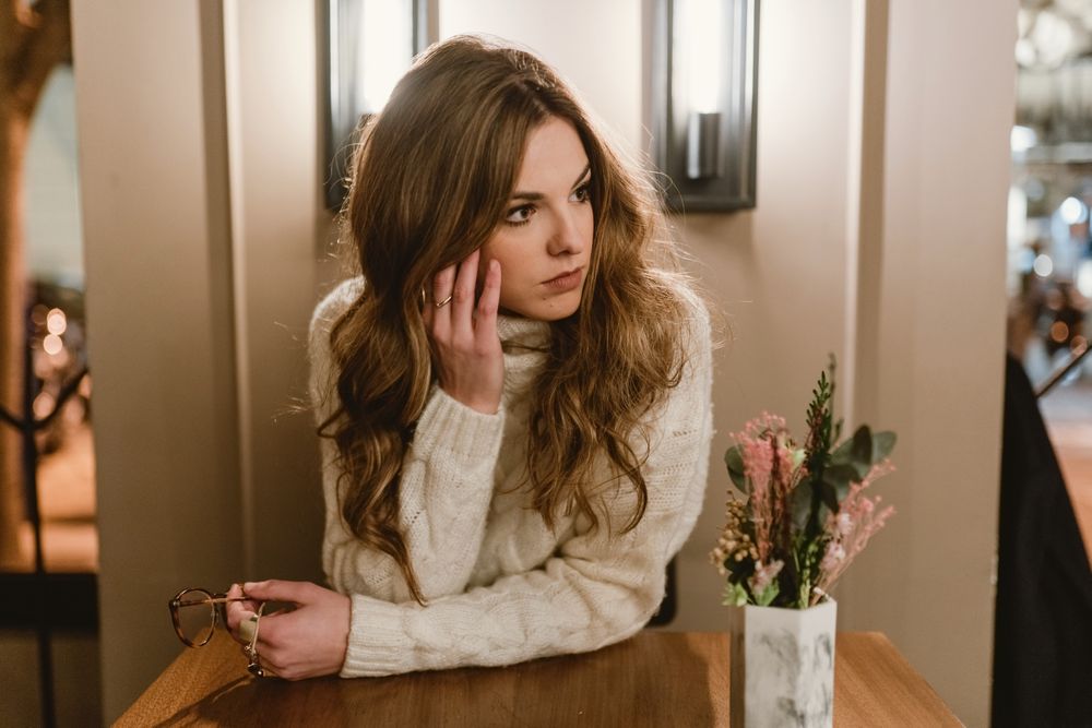 female at cafe table