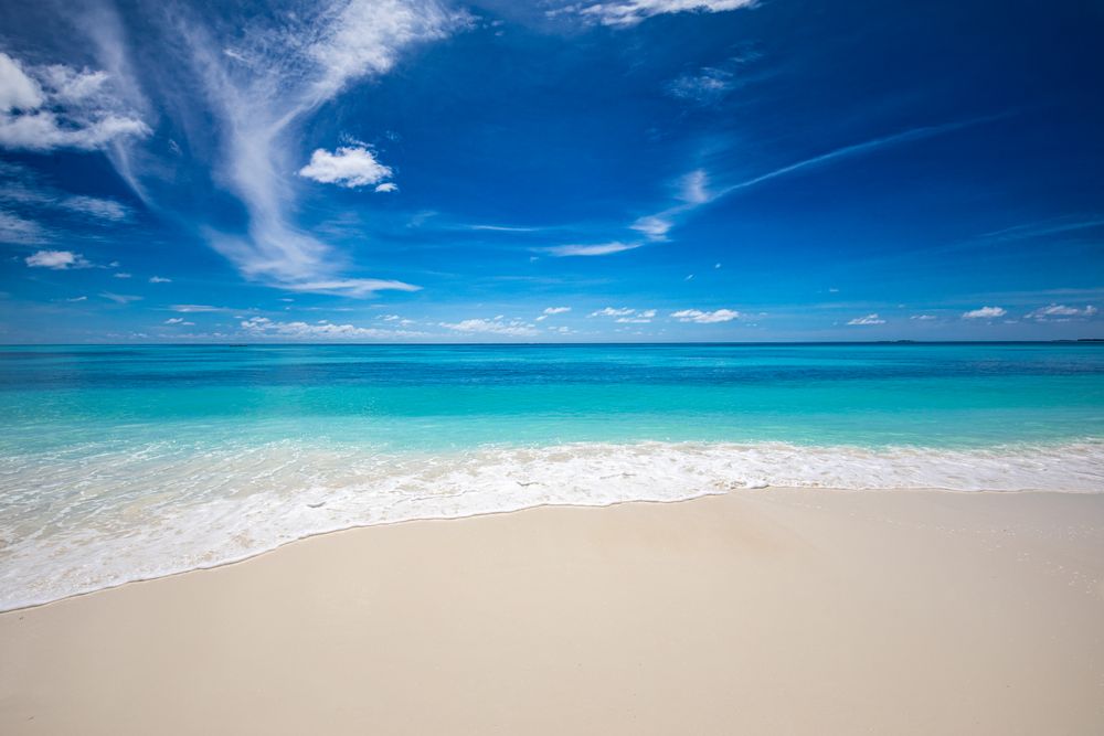 Waves coming up onto a clean tropical beach