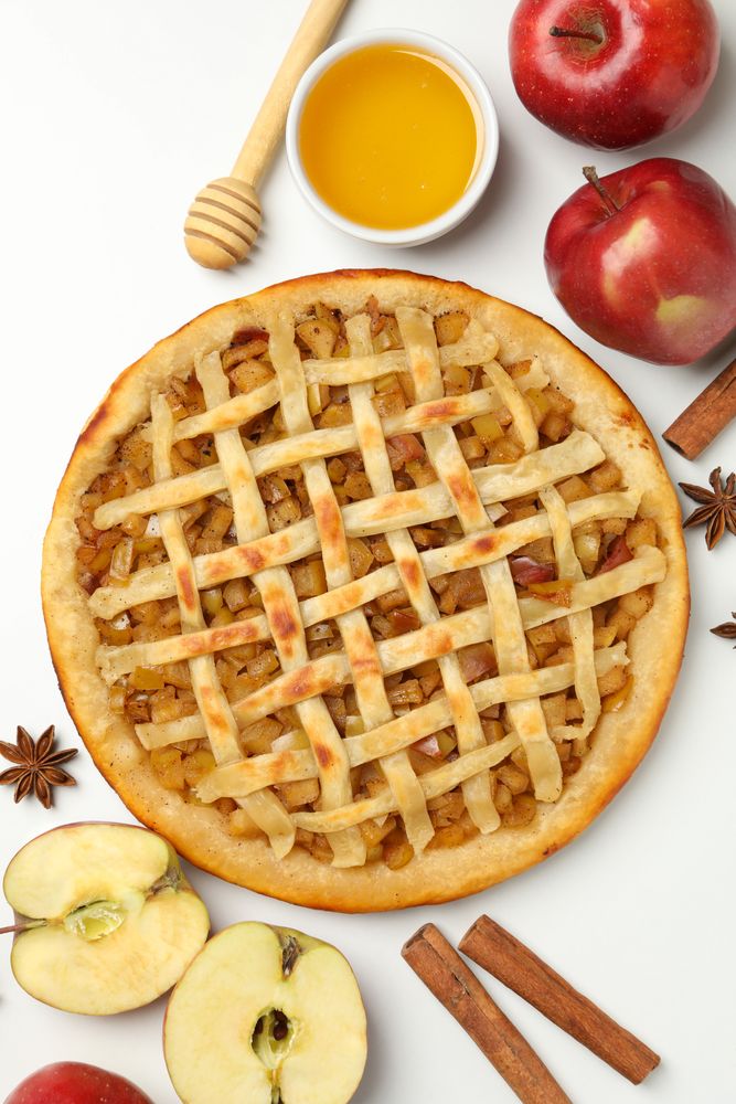 Composition with tasty apple pie on background, top view