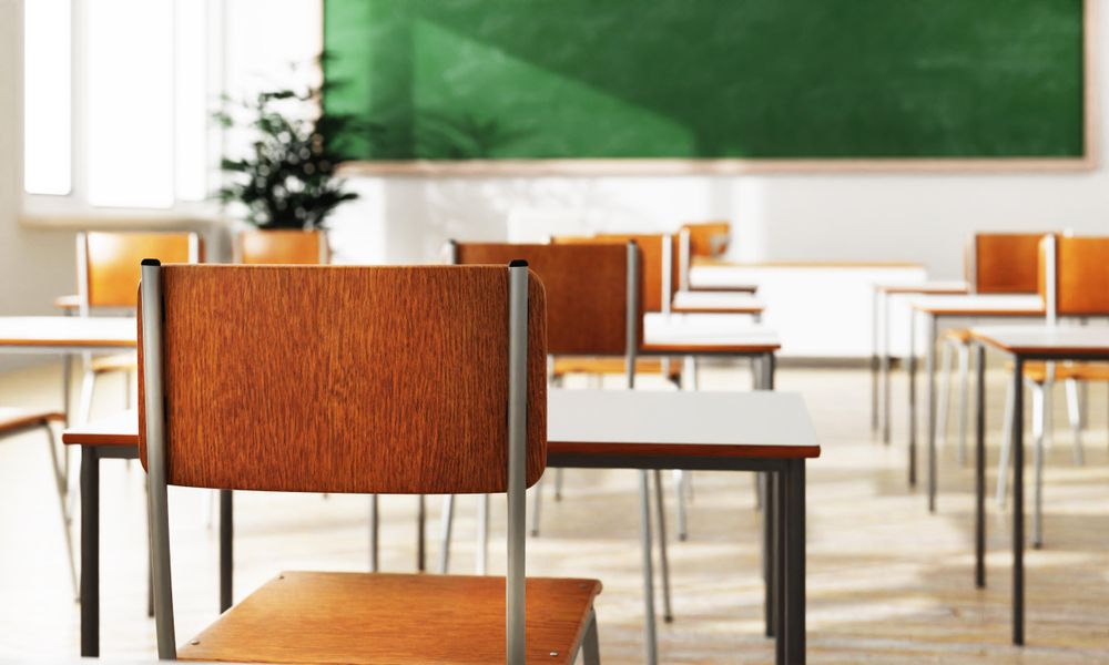 Empty chair in school looking towards the front of class