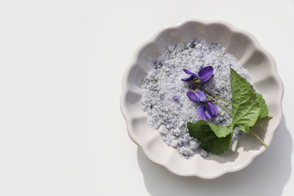 Homemade herbal sugar decorated by violet flowers and leaves