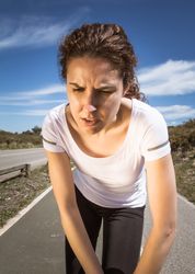 Close up of woman's face as she stretches outside