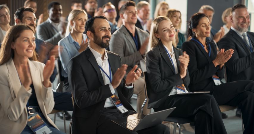 Crowd of Smart Tech People Applauding in Conference Hall During a Motivational Keynote Presentation By Innovative Company.