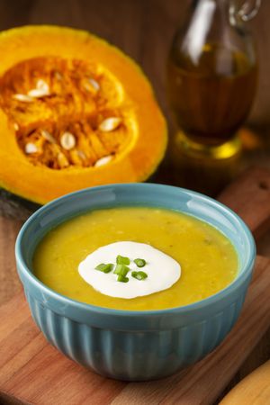 Bowl with pumpkin soup on the table.