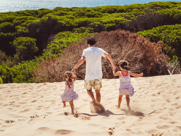 Anonymous family walking in the beach