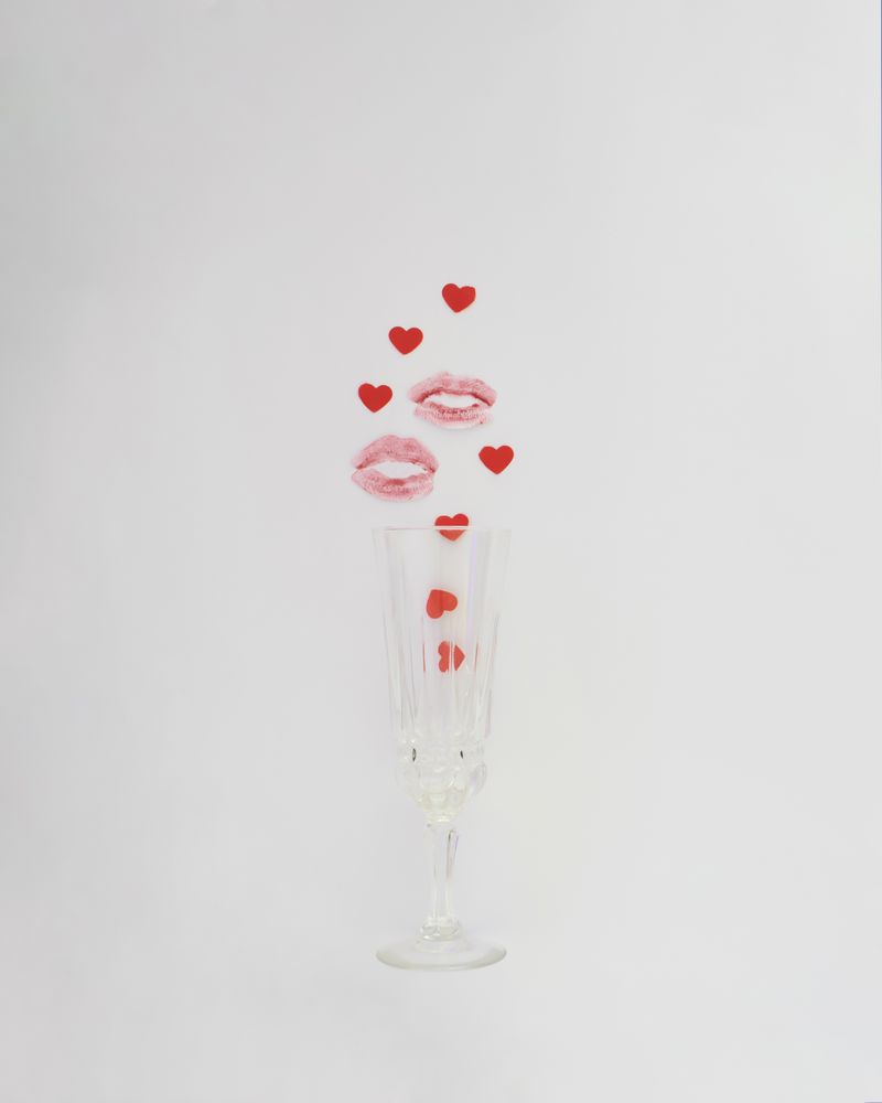 Champagne flute with lipstick mark and hearts