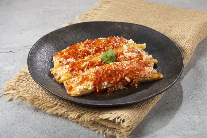 Pancakes stuffed with minced meat and topped with tomato sauce and grated cheese.