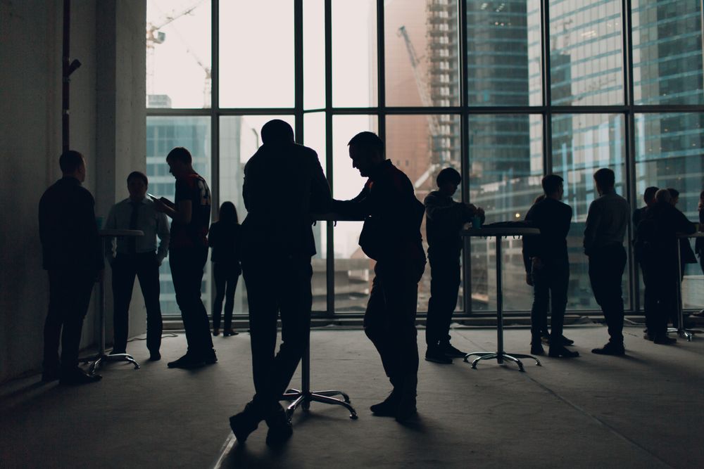 Silhouette of businessmen at a gathering in an office