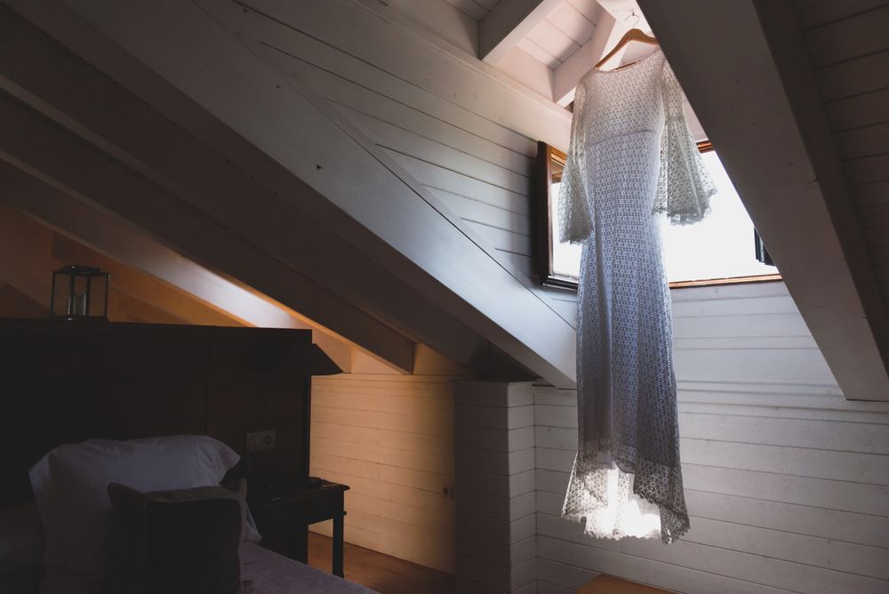Dress hanging near window in room