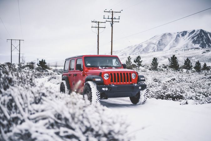 Red SUV in snowy field