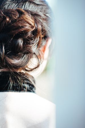 Close up shot of woman with brunette hair fashioned into a bun
