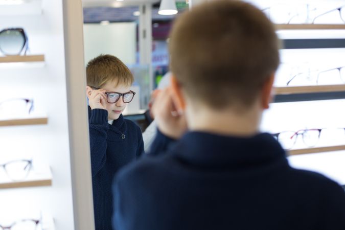 Young boy trying on glasses