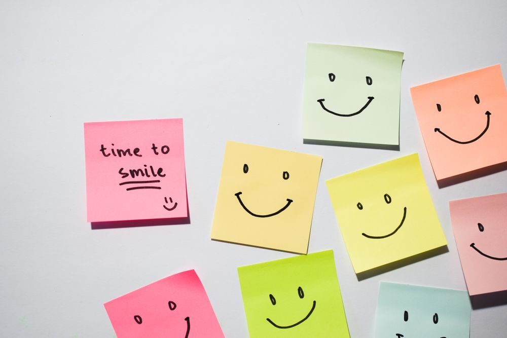 Time to smile and smiley emoticon on sticky notes