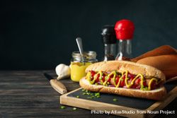 Tasty hot dog and ingredients on wooden background 4mWOlQ
