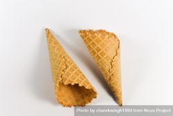 Two waffle cones lying on plain table 0WY7p4