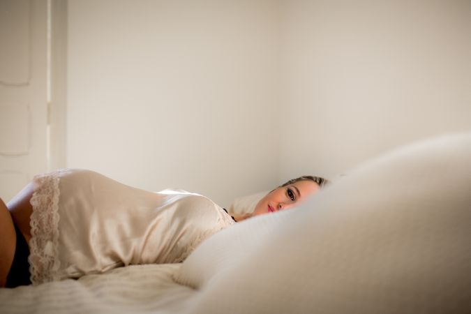 pregnant woman lying on bed