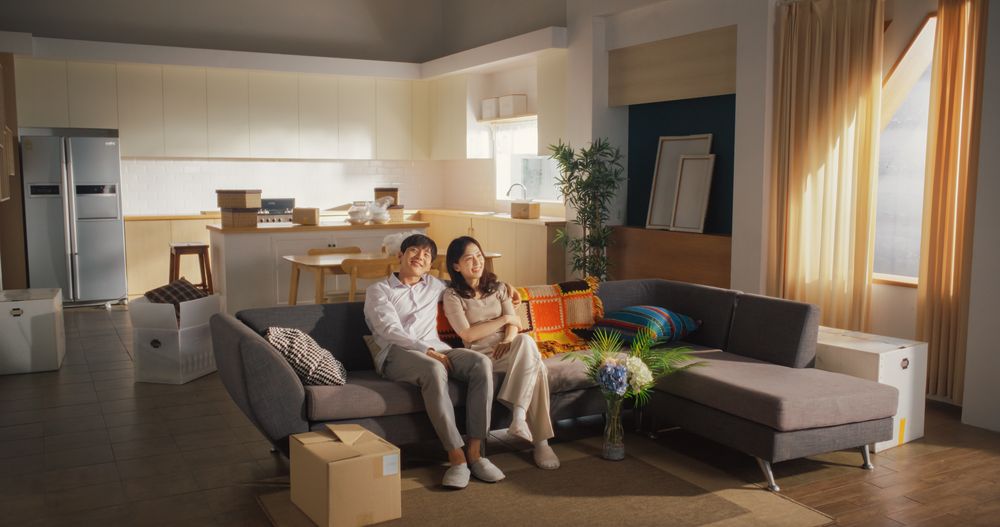Family Moving in: Happy and Excited Young Korean Couple Sitting in Their Newly Purchased Apartment.