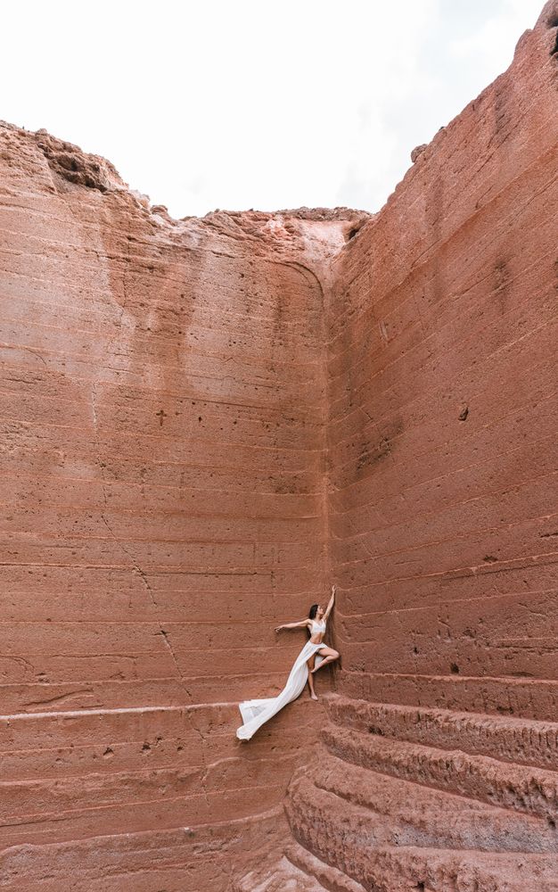 Elegant female posing on rocky cliff