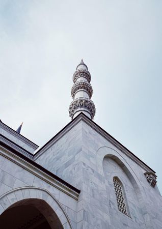 Minaret of mosque on overcast day in Turkey