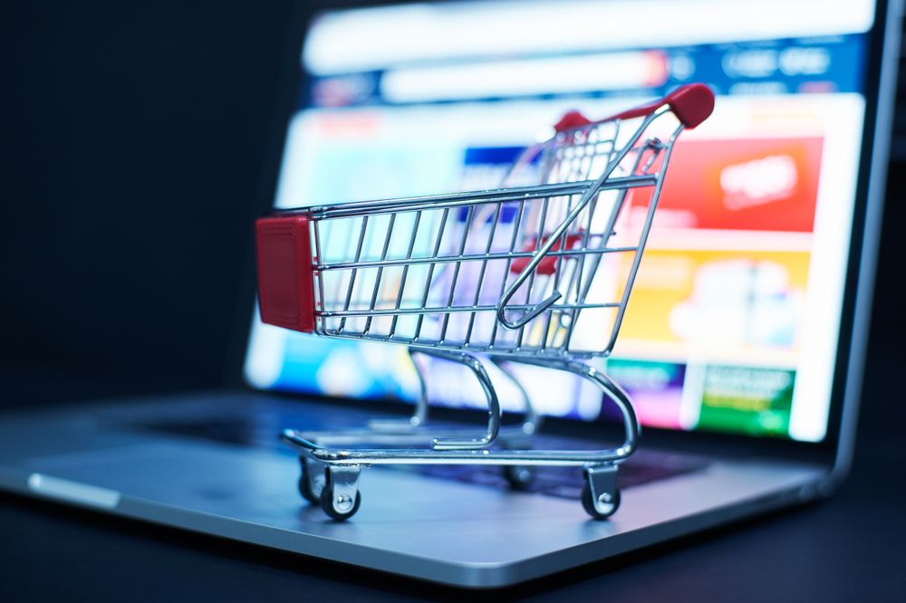 Shopping Cart Symbolizing Online Shopping on Laptop Screen