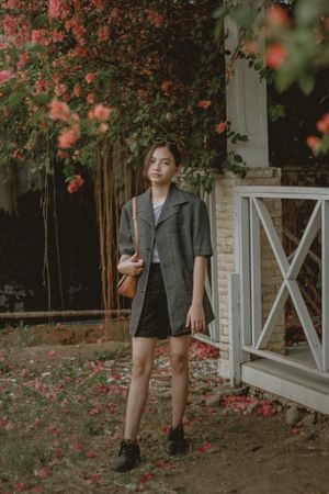 Teenage girl standing in garden
