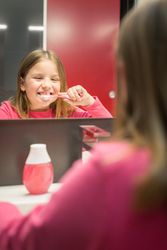 Cute girl brushing her teeth