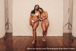 Full length of two women in neutral undergarments in studio 0yVpG5