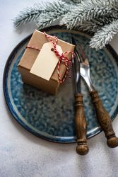 Christmas table setting of blue plate with present