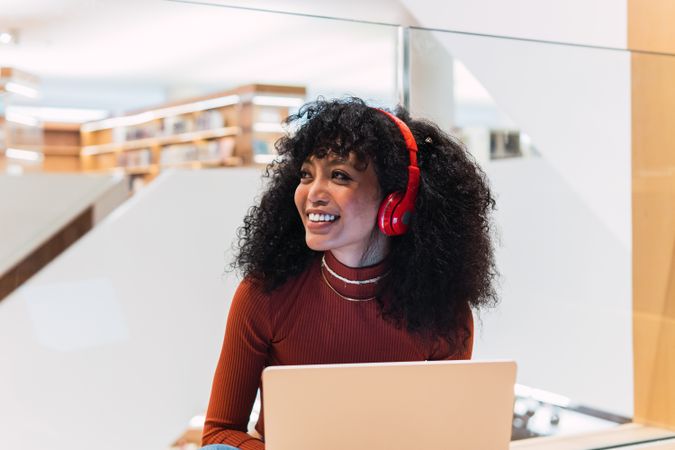 Happy female listened to music from laptop