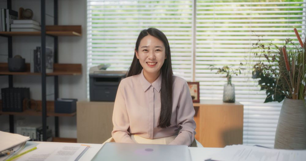 Portrait of Korean Female Working on Laptop Computer in her Modern Office.