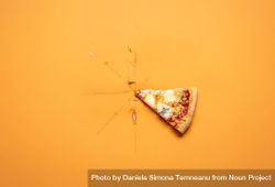 Single pizza slice on orange background 5RMaN0