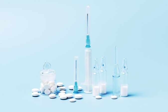 Variety of pharmaceutical items on blue backdrop