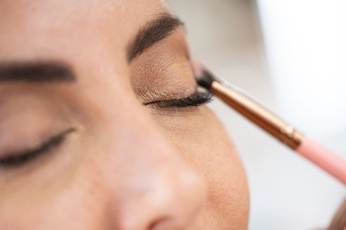 Woman having flattering eye shadow applied in spa