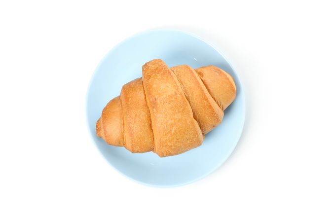 Top view of plate with croissant isolated on plain background