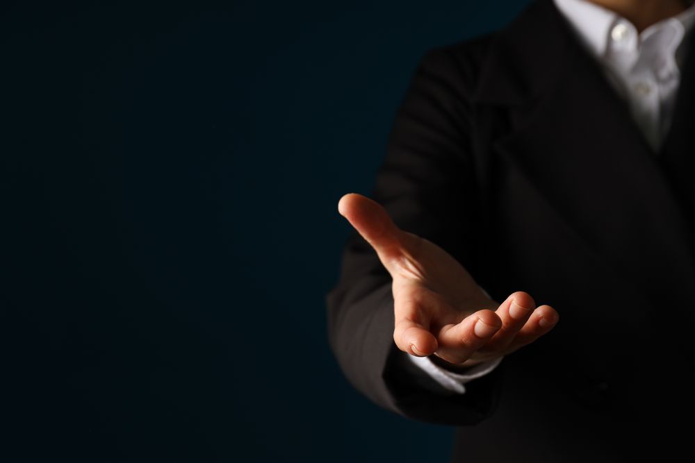 Businessman's hand close-up on a dark background