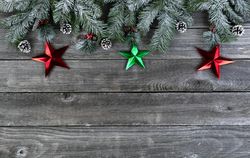 Snowy fir with stars on age wooden planks