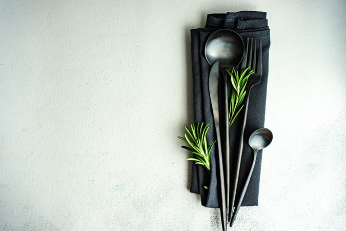 Modern dark cutlery set on grey counter