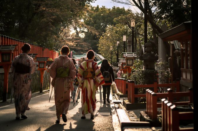 Back view of Japanese women in kimonos walking in an ancient road in Japan
