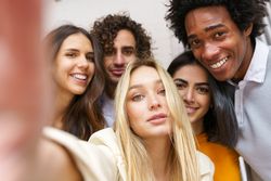 Friends smiling for a selfie outside