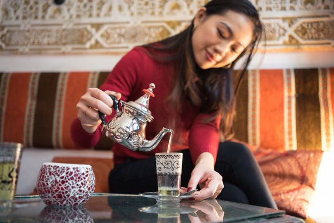 Asian woman enjoying Arabic tea