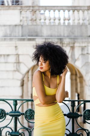 Stylish female leaning on railing outdoors
