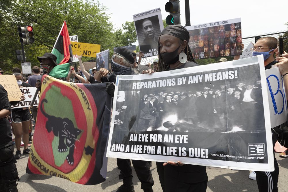 Group of protesters holding reparations, George Floyd, and Black Panther signs, Washington, D.C.