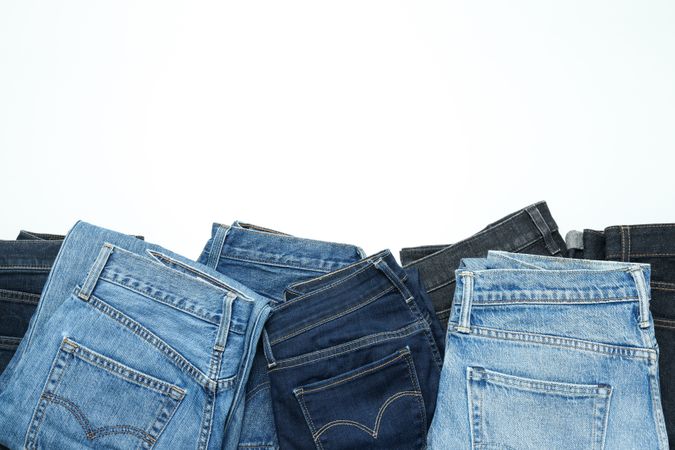 Folded jeans on a light background