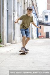 Front view of serious skater boy riding on the street 4AzloQ