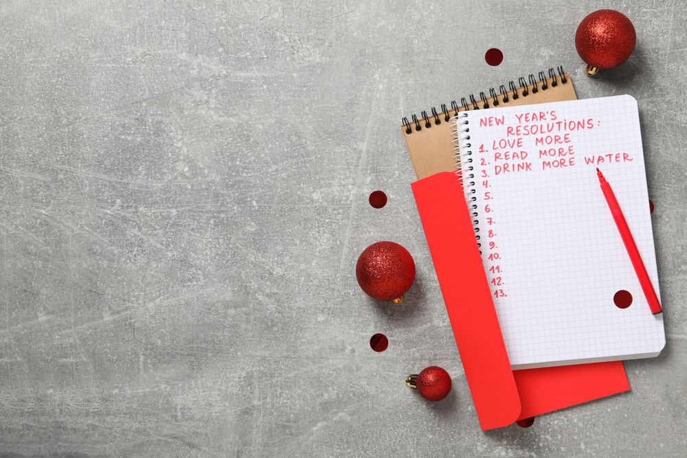 Envelope, notepad with list and balls on gray background, space for text