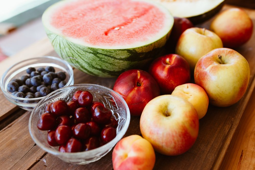 Delicious summer fruits on wooden table