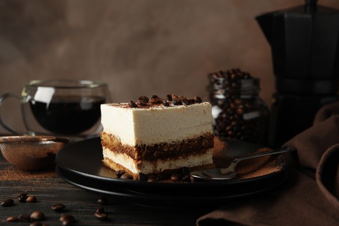 Composition with tasty tiramisu and coffee on wooden background