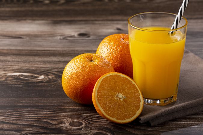 Glass with orange juice on the table.